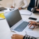 Finance professionals reviewing reports and data during an office meeting