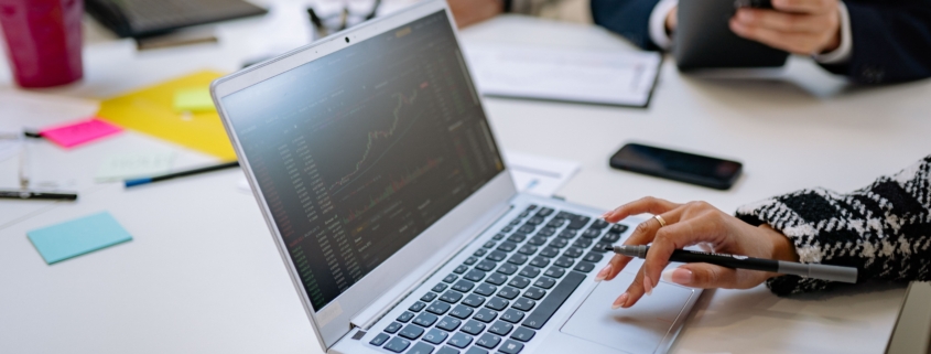 Finance professionals reviewing reports and data during an office meeting
