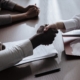 Business partners shaking hands over contract documents, illustrating customer relationship concentration risk