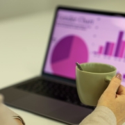 Laptop showing financial charts for a corporate investment and business spending forecast