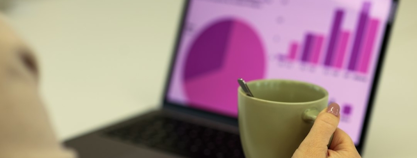 Laptop showing financial charts for a corporate investment and business spending forecast