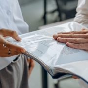 Business professionals reviewing documents together during a pricing and financial planning discussion