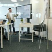 Executive financial strategy presentation — Vitaly Gariev / Unsplash Executive presenting financial strategy and investment analysis to colleagues in a boardroom