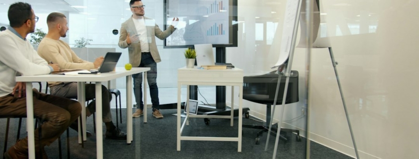 Executive presenting financial strategy and investment analysis to colleagues in a boardroom
