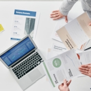 Executive team reviewing financial reports – Tiger Lily / Pexels Overhead view of an executive team reviewing financial documents together during a strategic planning meeting