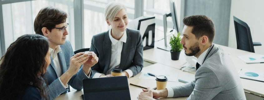 Finance leaders discussing forecasts in a meeting