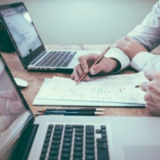 Finance team reviewing forecast assumptions — Scott Graham / Unsplash Finance professionals reviewing financial charts and documents during a forecasting meeting