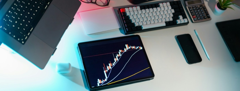 Laptop and financial analysis workspace illustrating an Excel financial forecast model