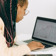 Gross margin forecasting Finance professional reviewing financial charts and margin trends on a laptop