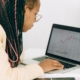 Finance professional reviewing financial charts and margin trends on a laptop