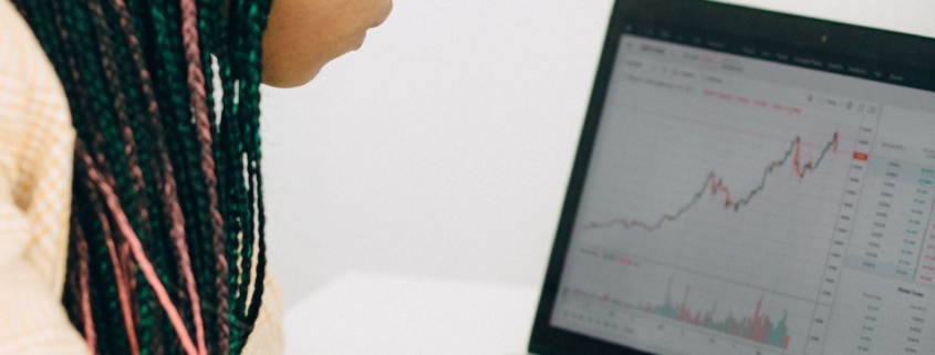 Finance professional reviewing financial charts and margin trends on a laptop