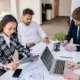 Business team reviewing planning documents during a headcount forecasting meeting