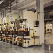 Rows of industrial production machinery on a manufacturing factory floor