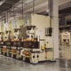 Rows of industrial production machinery on a manufacturing factory floor