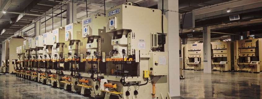 Rows of industrial production machinery on a manufacturing factory floor