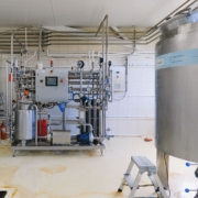 Industrial manufacturing equipment inside a modern factory, illustrating a lease versus buy equipment decision
