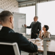 Senior leader presenting growth charts — Pexels Senior leader presenting growth charts